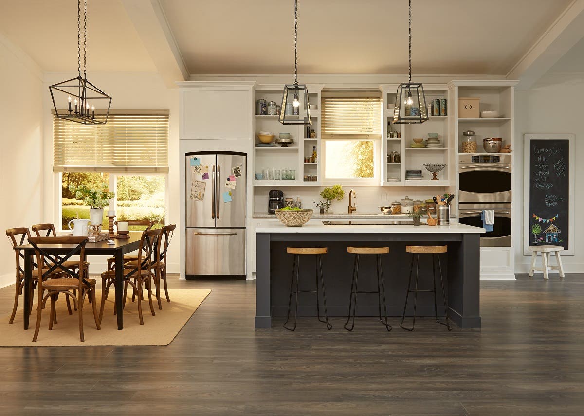 Modern farmhouse kitchen and dining room with partially closed motorized wood blinds